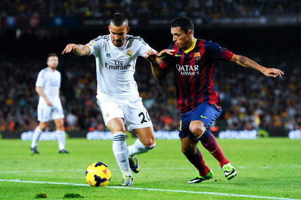 BARCELONA, SPAIN - OCTOBER 26:  Jesse Rodriguez of Real Madrid CF duels for the ball with Adriano Correia of FC Barcelona during the La Liga match between FC Barcelona and Real Madrid CF at Camp Nou on October 26, 2013 in Barcelona, Spain.  (Photo by Davi