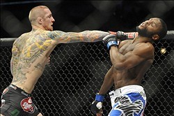 Jan 25, 2014; Chicago, IL, USA; Eddie Wineland (red gloves) fights Yves Jabouin (blue gloves) during UFC on FOX 10 at the United Center. Mandatory Credit: David Banks-USA TODAY Sports