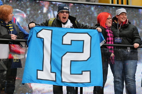 NEW YORK CITY, NY - JANUARY 31:  Seattle Seahawks fan, Andy Stevenson of Seattle, WA poses with a 12th man flag as he visits Times Square on January 31, 2014 in New York City.  Broadway has temporarily been re-named Super Bowl Boulevard as the city prepar
