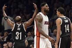 Jan 10, 2014; Brooklyn, NY, USA; Brooklyn Nets shooting guard Jason Terry (31) celebrates  while Miami Heat small forward LeBron James (6) walks back to the bench during the first half at Barclays Center. Mandatory Credit: Joe Camporeale-USA TODAY Sports