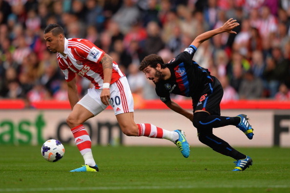 STOKE ON TRENT, ENGLAND - AUGUST 24:  Geoff Cameron of Stoke battles with Jose Campana of Palace during the Barclays Premier League match between Stoke City and Crystal Palace at Britannia Stadium on August 24, 2013 in Stoke on Trent, England.  (Photo by 