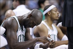 Apr 26, 2013; Boston, MA, USA; Boston Celtics forward/center Kevin Garnett (5) and small forward Paul Pierce (34) sit on the bench during the fourth quarter of game three of the first round of the 2013 NBA playoffs against the New York Knicks at TD Garden