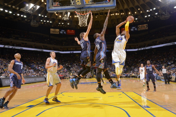 OAKLAND, CA - FEBRUARY 4: Andre Iguodala #9 of the Golden State Warriors shoots against Josh McRoberts #11 and Michael Kidd-Gilchrist #14 of the Charlotte Bobcats on February 4, 2014 at Oracle Arena in Oakland, California. NOTE TO USER: User expressly ack