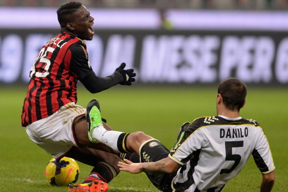 MILAN, ITALY - JANUARY 22:  Mario Balotelli of AC Milan #45 and Danilo of Udinese Calcio compete for the ball during the TIM Cup match between AC Milan and Udinese Calcio at Stadio Giuseppe Meazza on January 22, 2014 in Milan, Italy.  (Photo by Claudio Vi