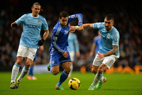 MANCHESTER, ENGLAND - FEBRUARY 03: Martin Demichelis of Manchester City (L) looks on as Eden Hazard of Chelsea shrugs off a challenge from Aleksandar Kolarov of Manchester City during the Barclays Premier League match between Manchester City and Chelsea a