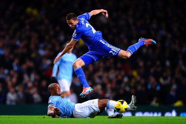 MANCHESTER, ENGLAND - FEBRUARY 03:  Vincent Kompany of Manchester City tackles Nemanja Matic of Chelsea  during the Barclays Premier League match between Manchester City and Chelsea at Etihad Stadium on February 3, 2014 in Manchester, England.  (Photo by 