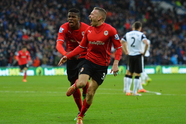 CARDIFF, WALES - FEBRUARY 01:  Craig Bellamy of Cardiff City celebrates with Wilfried Zaha (L) as he scores their first goal during the Barclays Premier League match between Cardiff City and Norwich City at Cardiff City Stadium on February 1, 2014 in Card