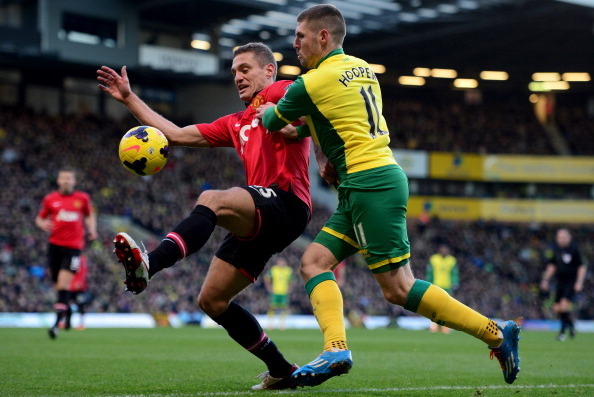 NORWICH, ENGLAND - DECEMBER 28:  Nemanja Vidic of Manchester United battles with Gary Hooper of Norwich City during the Barclays Premier League match between Norwich City and  Manchester United at Carrow Road on December 28, 2013 in Norwich, England.  (Ph