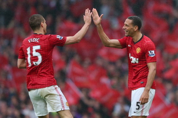 MANCHESTER, ENGLAND - MAY 12:  Rio Ferdinand of Manchester United celebrates scoring the winning goal with team-mate Nemanja Vidic during the Barclays Premier League match between Manchester United and Swansea City at Old Trafford on May 12, 2013 in Manch