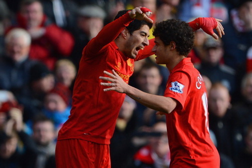 LIVERPOOL, ENGLAND - MARCH 10: Luis Suarez of Liverpool celebrates his goal to make it 1-0 with Philippe Coutinho during the Barclays Premier League match between Liverpool and Tottenham Hotspurs at Anfield on March 10, 2013 in Liverpool, England.  (Photo