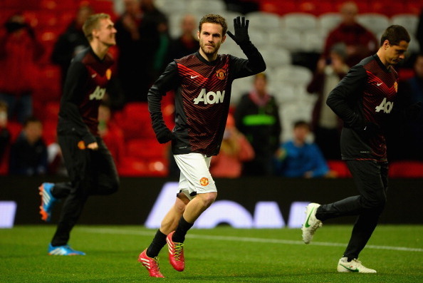 MANCHESTER, ENGLAND - JANUARY 28:  New signing Juan Mata of Manchester United waves to the fans during his warm up prior to the Barclays Premier League match between Manchester United and Cardiff City at Old Trafford on January 28, 2014 in Manchester, Eng
