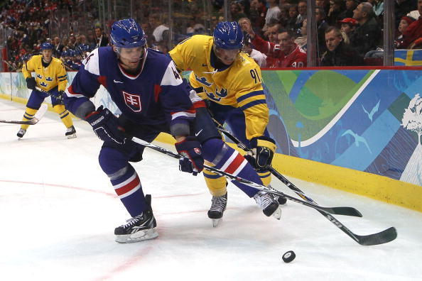 VANCOUVER, BC - FEBRUARY 24: Andrej Sekera #44 of Slovakia battles for the puck with Loui Eriksson #91 of Sweden during the ice hockey men's quarter final game between Sweden and Slovakia on day 13 of the Vancouver 2010 Winter Olympics at Canada Hockey Pl