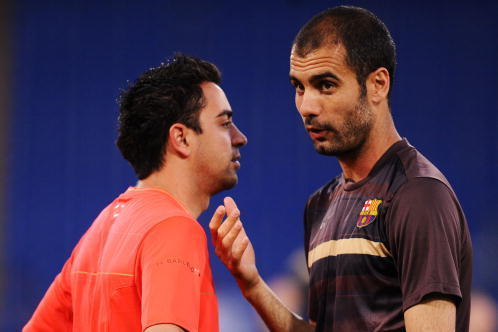 ROME - MAY 26:  Josep Guardiola coach of Barcelona speaks to Xavi during the Barcelona training session prior to UEFA Champions League Final versus Manchester United at the Stadio Olimpico on May 26, 2009 in Rome, Italy.  (Photo by Jasper Juinen/Getty Ima