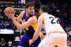 Jan 15, 2014; Phoenix, AZ, USA; Los Angeles Lakers center Pau Gasol (16) handles the ball against the Phoenix Suns forward Miles Plumlee (22) in the first half at US Airways Center. Mandatory Credit: Jennifer Stewart-USA TODAY Sports