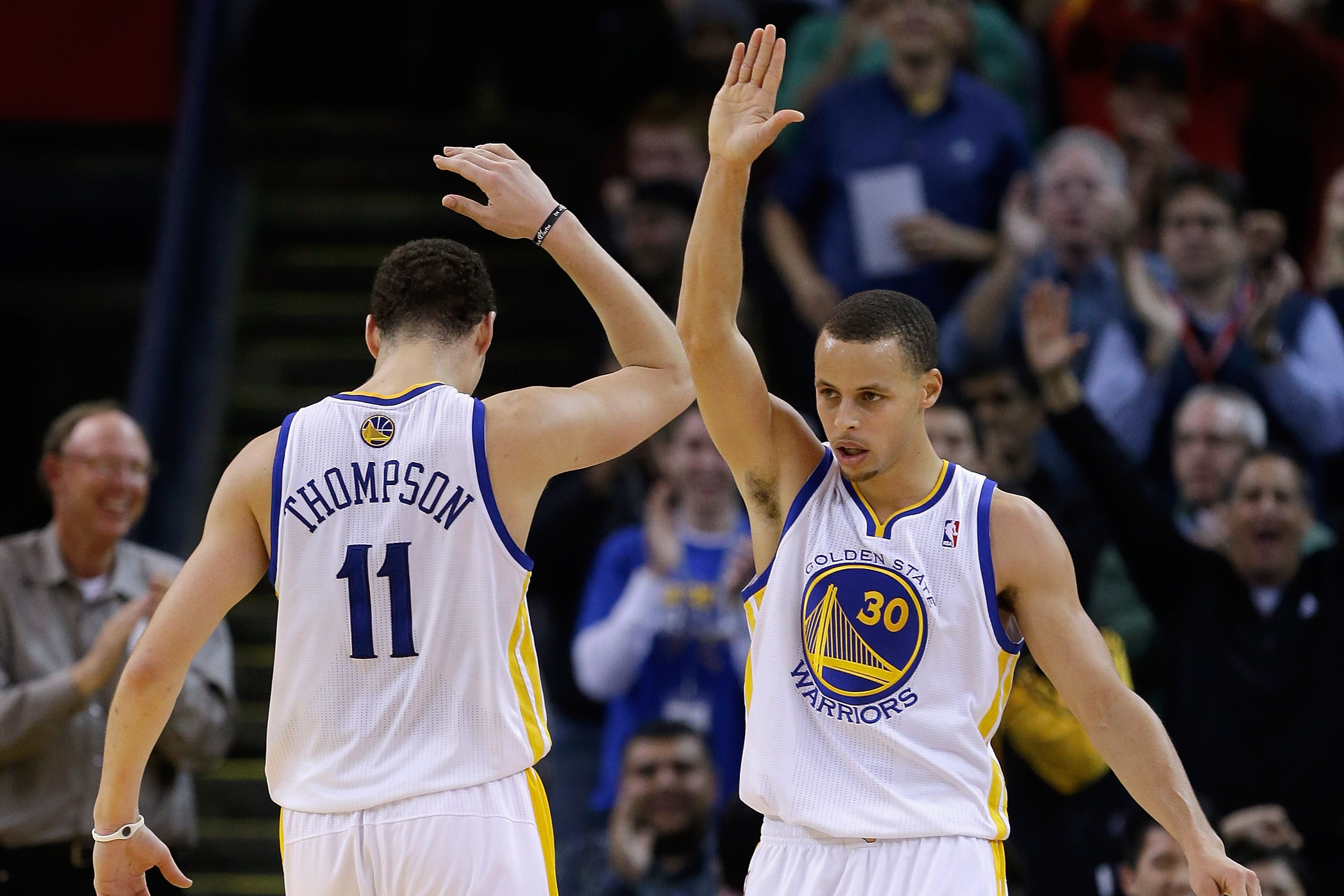 OAKLAND, CA - JANUARY 23:  Stephen Curry #30 of the Golden State Warriors is congratulated by Klay Thompson #11 after Curry made a basket and was fouled during their game against the Oklahoma City Thunder at Oracle Arena on January 23, 2013 in Oakland, Ca
