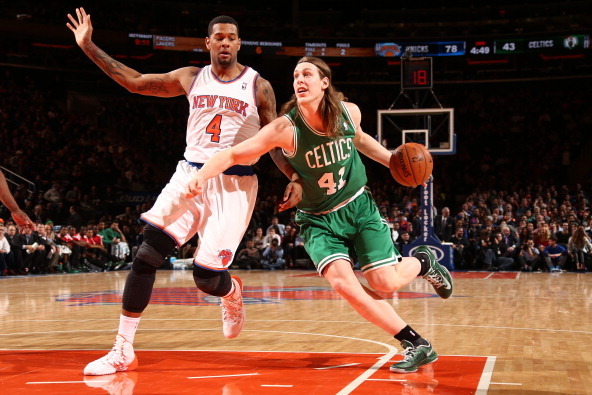 NEW YORK, NY - JANUARY 28: Kelly Olynyk #41 of the Boston Celtics dribbles past Jeremy Tyler #4 of the New York Knicks during a game at Madison Square Garden in New York City on January 28, 2014.  NOTE TO USER: User expressly acknowledges and agrees that,