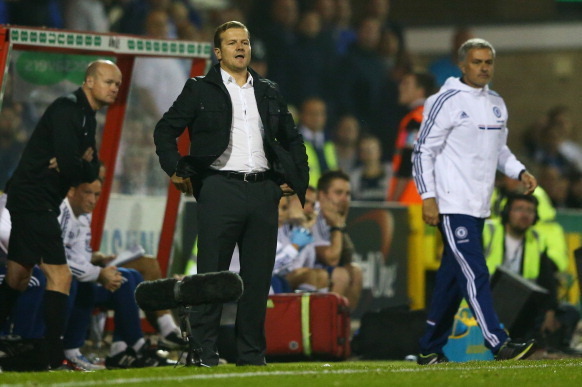 SWINDON, ENGLAND - SEPTEMBER 24:  Mark Cooper manager of Swindon Town and Jose Mourinho manager of Chelsea look on from the touchline during the Capital One Cup Third Round match between Swindon Town and Chelsea at County Ground on September 24, 2013 in S
