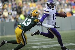 Nov 24, 2013; Green Bay, WI, USA;   Minnesota Vikings wide receiver Greg Jennings (15) is chased by Green Bay Packers safety M.D. Jennings (43) after making a catch in the 3rd quarter at Lambeau Field. Mandatory Credit: Benny Sieu-USA TODAY Sports