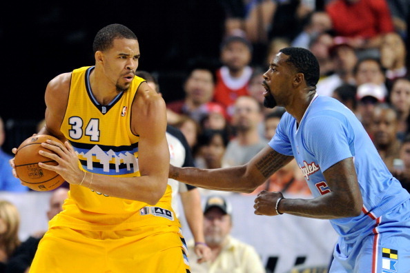 LAS VEGAS, NV - OCTOBER 19:  JaVale McGee #34 of the Denver Nuggets is guarded by DeAndre Jordan #6 of the Los Angeles Clippers during their preseason game at the Mandalay Bay Events Center on October 19, 2013 in Las Vegas, Nevada. Los Angeles won 118-111