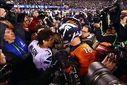 Feb 2, 2014; East Rutherford, NJ, USA; Seattle Seahawks quarterback Russell Wilson (3) shakes hands with Denver Broncos quarterback Peyton Manning (18) after Super Bowl XLVIII at MetLife Stadium.  Mandatory Credit: Mark J. Rebilas-USA TODAY Sports