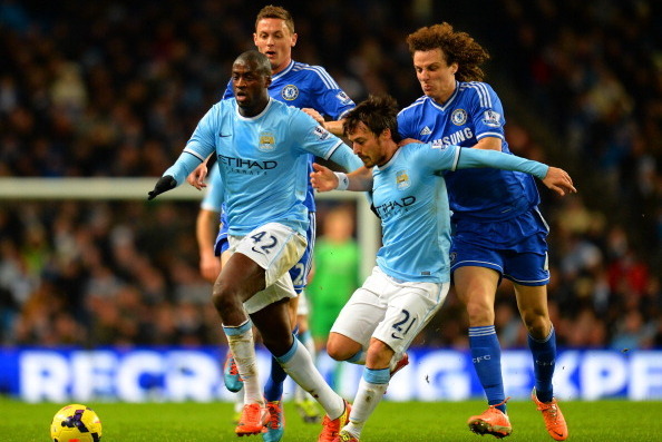 MANCHESTER, ENGLAND - FEBRUARY 03:  David Luiz of Chelsea grabs hold of David Silva of Manchester City as Yaya Toure of Manchester City and Nemanja Matic of Chelsea compete for the ball during the Barclays Premier League match between Manchester City and 