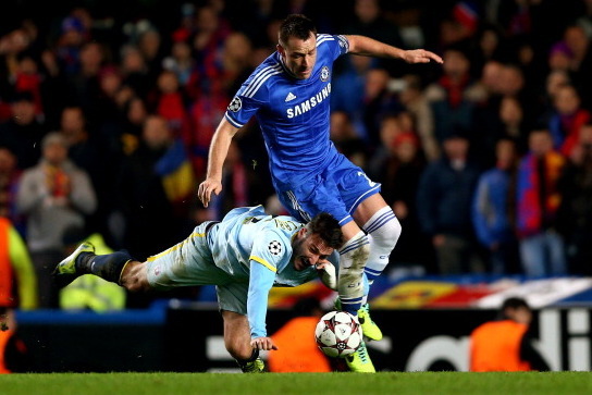 LONDON, ENGLAND - DECEMBER 11:  Federico Piovaccari of Steaua goes down under the challenge from John Terry of Chelsea during the UEFA Champions League Group E match between Chelsea and FC Steaua Bucuresti at Stamford Bridge on December 11, 2013 in London