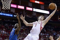 Oct 21, 2013; Houston, TX, USA; Houston Rockets center Omer Asik (3) grabs a rebound over Dallas Mavericks center Bernard James (5) during the third quarter at Toyota Center. The Rockets won 100-95. Mandatory Credit: Thomas Campbell-USA TODAY Sports