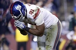Dec 1, 2013; Landover, MD, USA;  New York Giants defensive end Justin Tuck (91) celebrates after making a tackle against the Washington Redskins in the fourth quarter at FedEx Field. The Giants won 24-17. Mandatory Credit: Geoff Burke-USA TODAY Sports
