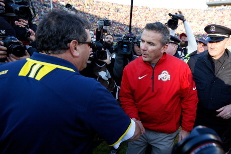 ANN ARBOR, MI - NOVEMBER 30:  Head coach Brady Hoke of the Michigan Wolverines and head coach Urban Meyer of the Ohio State Buckeyes meet on the field after the Ohio State Buckeyes defeated the Michigan Wolverines 42-41 at Michigan Stadium on November 30,
