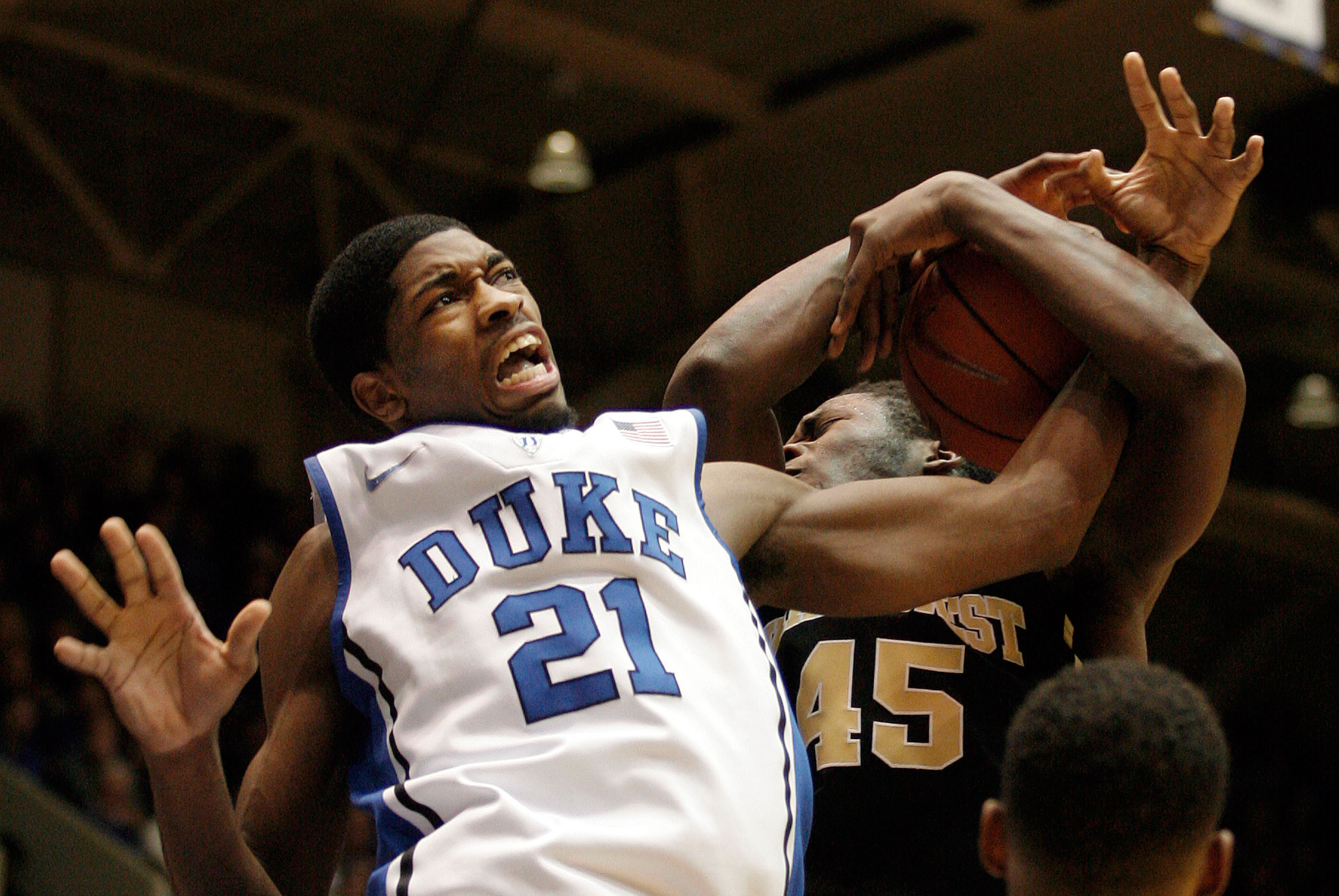 Feb 4, 2014; Durham, NC, USA; Duke Blue Devils forward Amile Jefferson (21) gets tangled with Wake Forest Demon Deacons forward Arnaud William Adala Moto (45) as they go for a rebound at Cameron Indoor Stadium. Mandatory Credit: Mark Dolejs-USA TODAY Spor