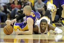 Feb 5, 2014; Cleveland, OH, USA; Cleveland Cavaliers point guard Kyrie Irving (right) battles for the ball with Los Angeles Lakers point guard Steve Blake in the third quarter at Quicken Loans Arena. Mandatory Credit: David Richard-USA TODAY Sports