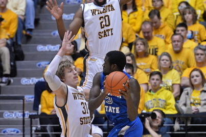 WICHITA, KS - JANUARY 18:  Ron Baker #31 and Kadeem Coleby #20 of the Wichita State Shockers defend against guard Manny Arop #3 of the Indiana State Sycamores during the first half on January 18, 2014 at Charles Koch Arena in Wichita, Kansas.  Wichita Sta
