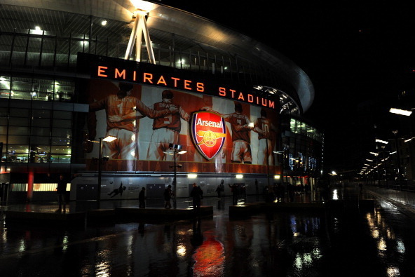 LONDON, ENGLAND - DECEMBER 23:  Football fans make their way to the stadium in heavy rain ahead of the Barclays Premier League match between Arsenal and Chelsea at Emirates Stadium on December 23, 2013 in London, England.  (Photo by Shaun Botterill/Getty 