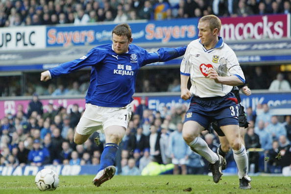 LIVERPOOL, ENGLAND - MARCH 13:  Wayne Rooney of Everton scores the winning goal past John Curtis of Portsmouth during the FA Barclaycard Premiership match between Everton and Portsmouth at Goodison Park on March 13, 2004 in Liverpool, England.  (Photo by 