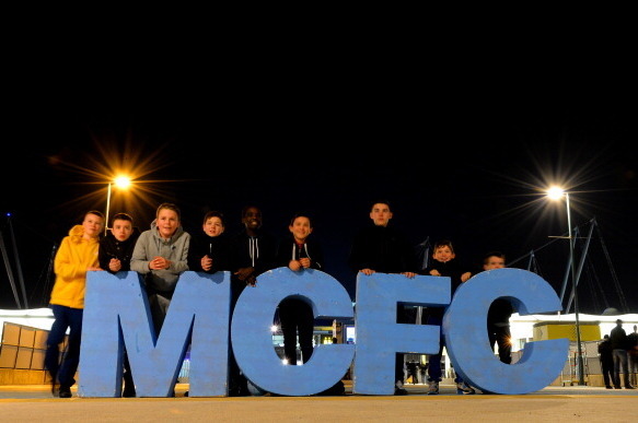 MANCHESTER, ENGLAND - FEBRUARY 03:  Kids pose by giant MCFC intials ahead of  the Barclays Premier League match between Manchester City and Chelsea at Etihad Stadium on February 3, 2014 in Manchester, England.  (Photo by Shaun Botterill/Getty Images)