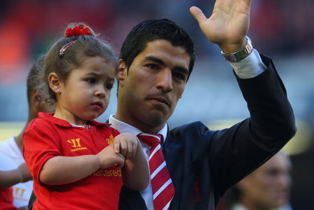 LIVERPOOL, ENGLAND - MAY 19:  Luis Suarez of Liverpool performs a lap of honour with daughter Delfina after the Barclays Premier League match between Liverpool and Queens Park Rangers at Anfield on May 19, 2013 in Liverpool, England.  (Photo by Julian Fin