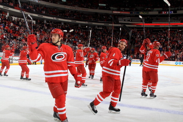 RALEIGH, NC - JANUARY 31: Tuomo Ruutu #15 of the Carolina Hurricanes and teammates salute fans following their victory over the St. Louis Blues during their NHL game at PNC Arena on January 31, 2014 in Raleigh, North Carolina.  (Photo by Gregg Forwerck/NH
