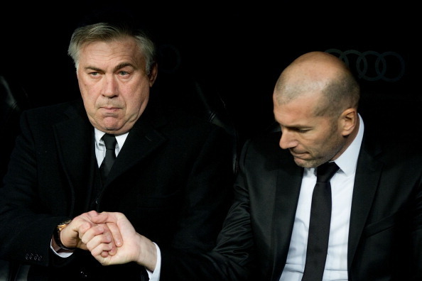 MADRID, SPAIN - FEBRUARY 05: Head coach Carlo Ancelotti (L) of Real Madrid CF shake hands with his assistant coach Zinedine Zidane (R) during the Copa del Rey semifinal first leg match between Real Madrid CF and Club Atletico Madrid at Estadio Santiago Be