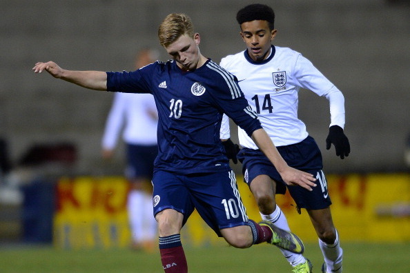 KIRKALDY,  SCOTLAND - NOVEMBER 29 :  MacKenzie Heaney of Scotland U16 out runs Jacob Maddox of England U16 during the Sky Sports Victory Shield match between Scotland U16 and England U16 on November 29, 2013 in Kirkaldy Scotland.  (Photo by Mark Runnacles