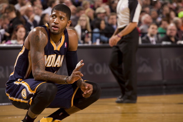 PORTLAND, OR - DECEMBER 2:  Paul George #24 of the Indiana Pacers kneels on the court against the Portland Trail Blazers on December 2, 2013 at the Moda Center Arena in Portland, Oregon. NOTE TO USER: User expressly acknowledges and agrees that, by downlo