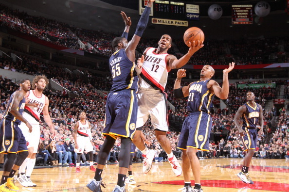PORTLAND, OR - DECEMBER 2: LaMarcus Aldridge #12 of the Portland Trail Blazers shoots against Roy Hibbert #55 of the Indiana Pacers on December 2, 2013 at the Moda Center Arena in Portland, Oregon. NOTE TO USER: User expressly acknowledges and agrees that