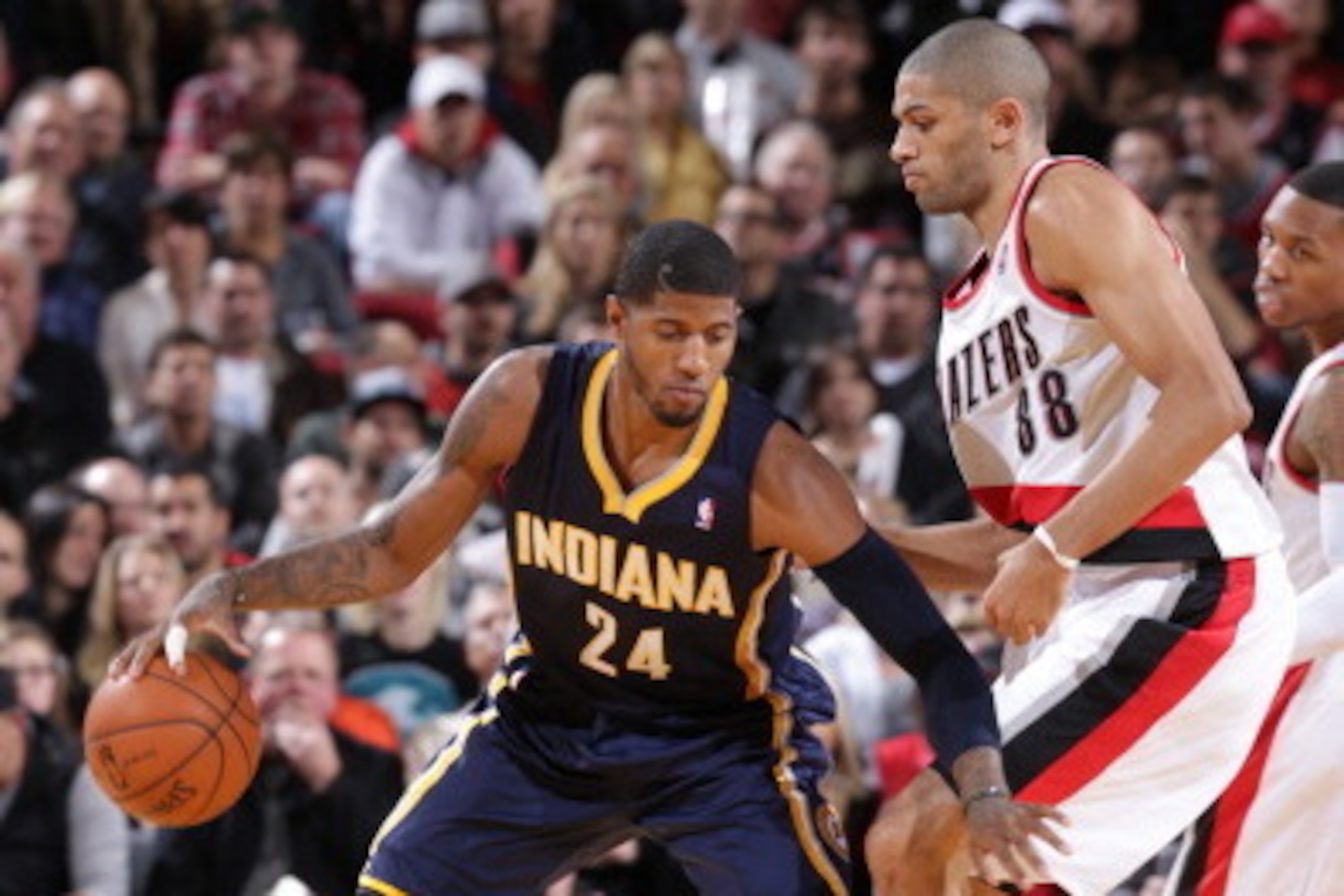 PORTLAND, OR - DECEMBER 2: Paul George #24 of the Indiana Pacers controls the ball against Nicolas Batum #88 of the Portland Trail Blazers on December 2, 2013 at the Moda Center Arena in Portland, Oregon. NOTE TO USER: User expressly acknowledges and agre