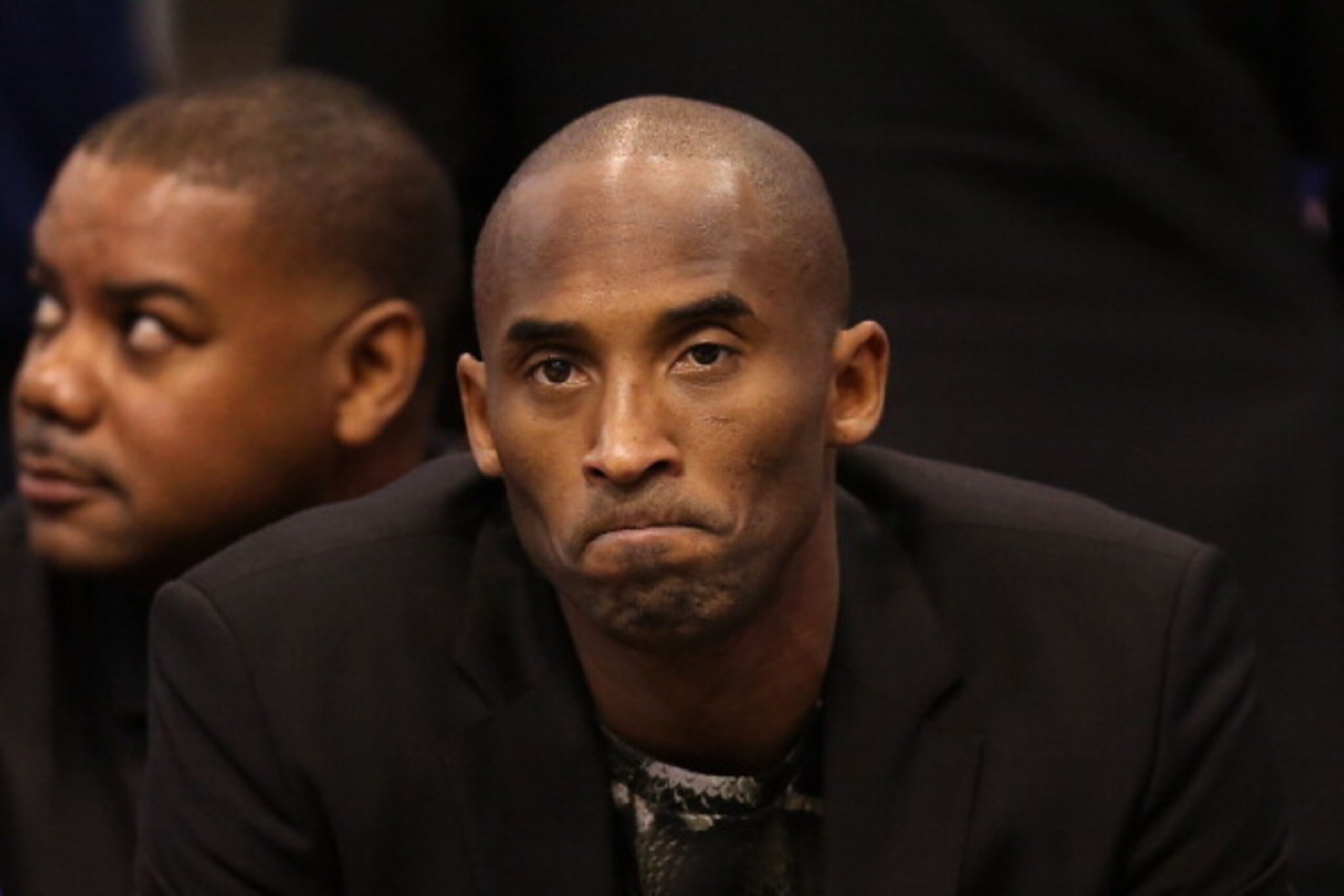 PHOENIX, AZ - JANUARY 15:  Kobe Bryant #24 of the Los Angeles Lakers watches from the bench during the NBA game against the Phoenix Suns at US Airways Center on January 15, 2014 in Phoenix, Arizona.  NOTE TO USER: User expressly acknowledges and agrees th