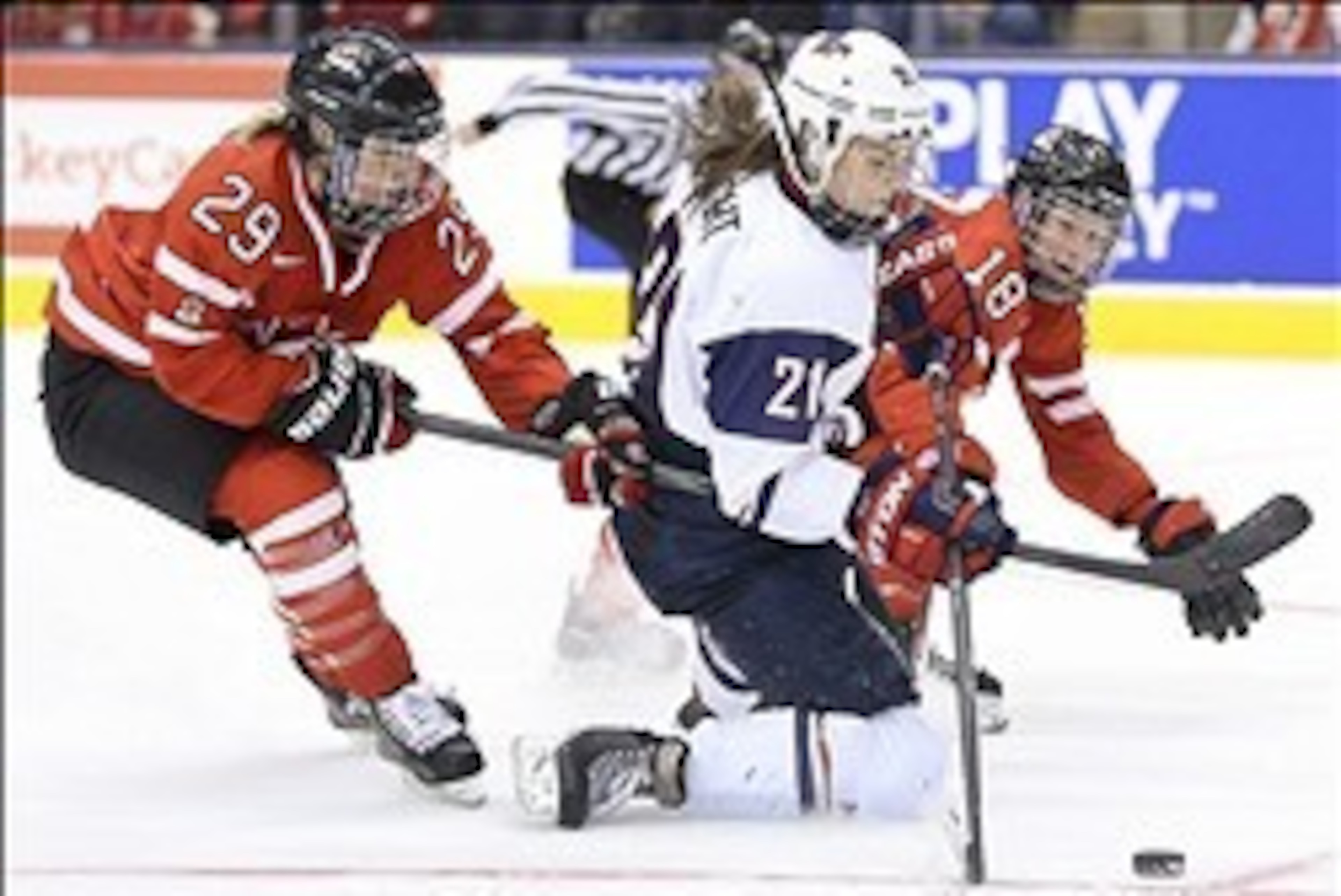 Dec 30, 2013; Toronto, Ontario, Canada; USA left wing Hilary Knight (21) skates with the puck as Canada forward Marie-Philip Poulin (29) and defenseman Catherine Ward (18) defend during the second period in an exhibition hockey game at Air Canada Centre. 