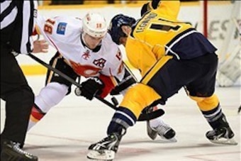 Jan 14, 2014; Nashville, TN, USA; Nashville Predators center David Legwand (11) faces off against Calgary Flames center Matt Stajan (18) during the third period at Bridgestone Arena. The Predators beat the Flames 4-2. Mandatory Credit: Don McPeak-USA TODA
