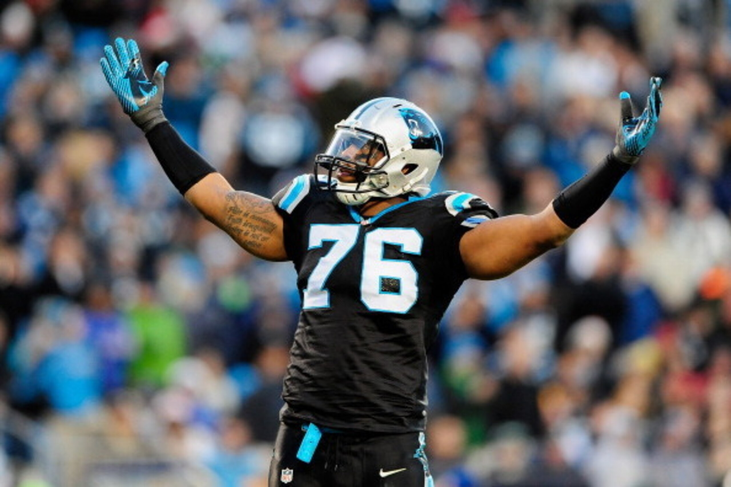 CHARLOTTE, NC - DECEMBER 15:  Greg Hardy #76 of the Carolina Panthers tells the fans to cheer against the New York Jets during play at Bank of America Stadium on December 15, 2013 in Charlotte, North Carolina.  (Photo by Grant Halverson/Getty Images)