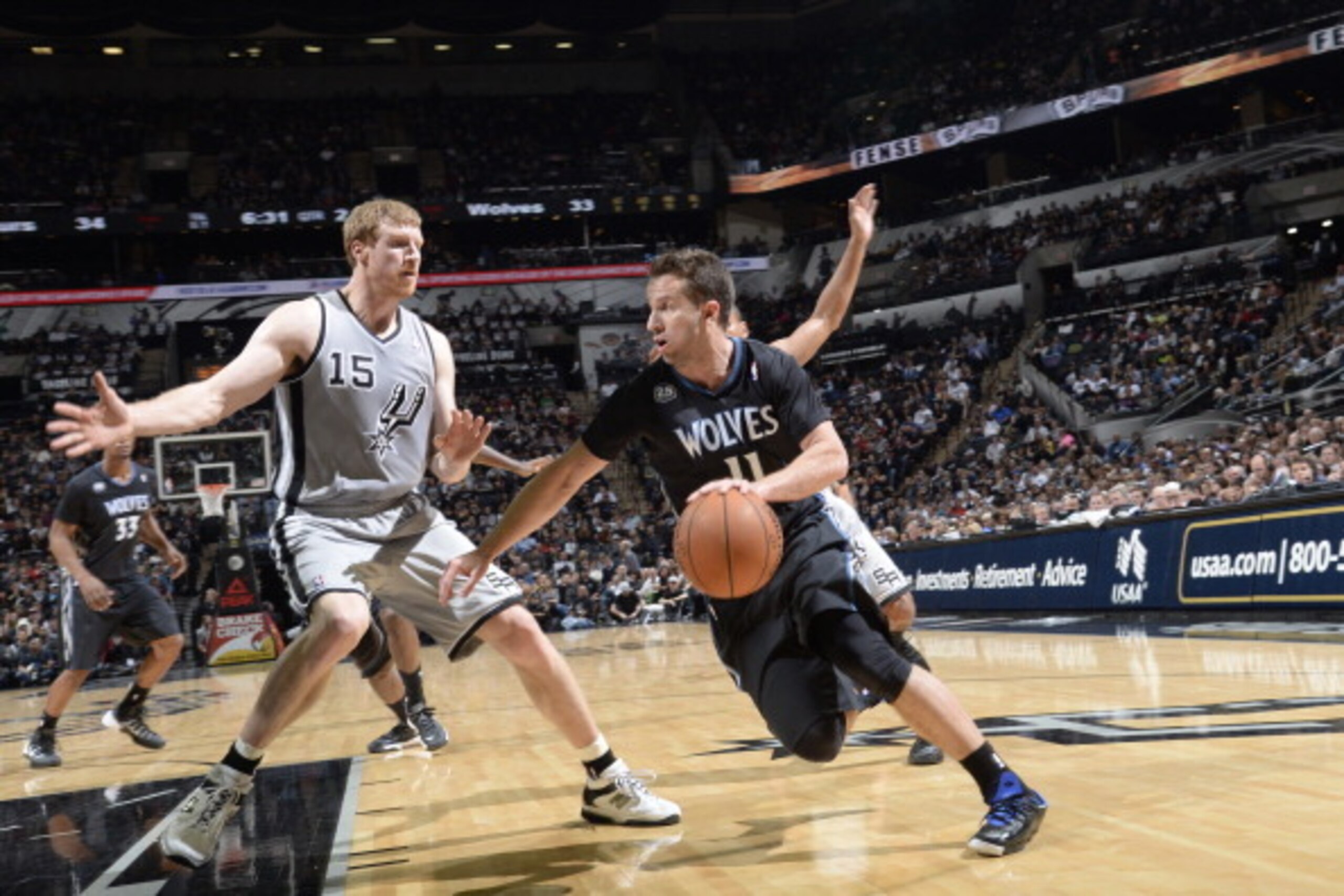 SAN ANTONIO, TX - January 12:  J.J. Barea #11 of the Minnesota Timberwolves handles the ball against Matt Bonner #15 of the San Antonio Spurs at the AT&T Center on January 12, 2014 in San Antonio, Texas. NOTE TO USER: User expressly acknowledges and agree