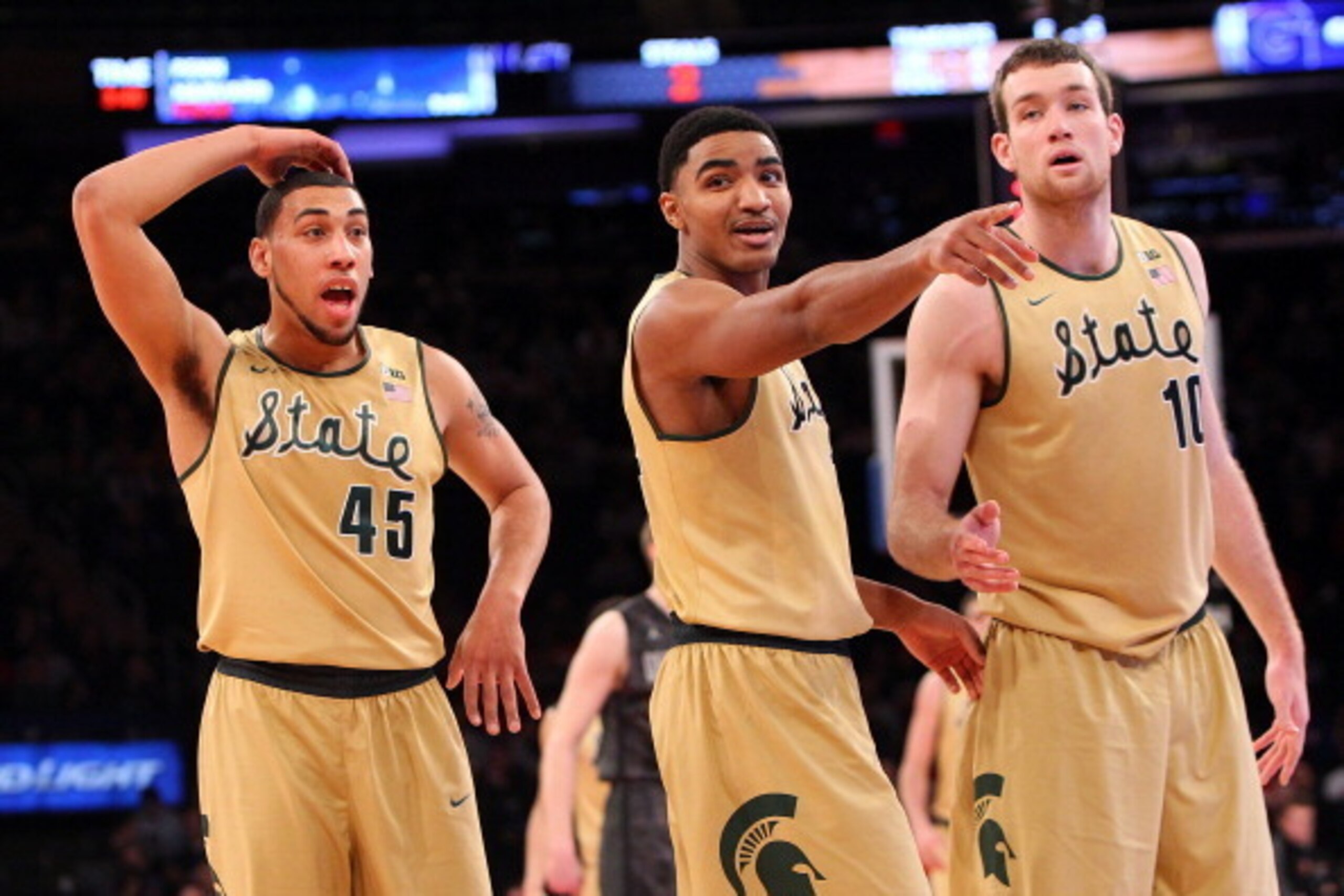 NEW YORK, NY - FEBRUARY 1:  Adreian Payne #5, Gary Harris #14 and Matt Costello #10 of the Michigan State Spartans point and react after a play during the game against the Georgetown Hoyas at Madison Square Garden on February 1, 2014 in New York City. (Ph