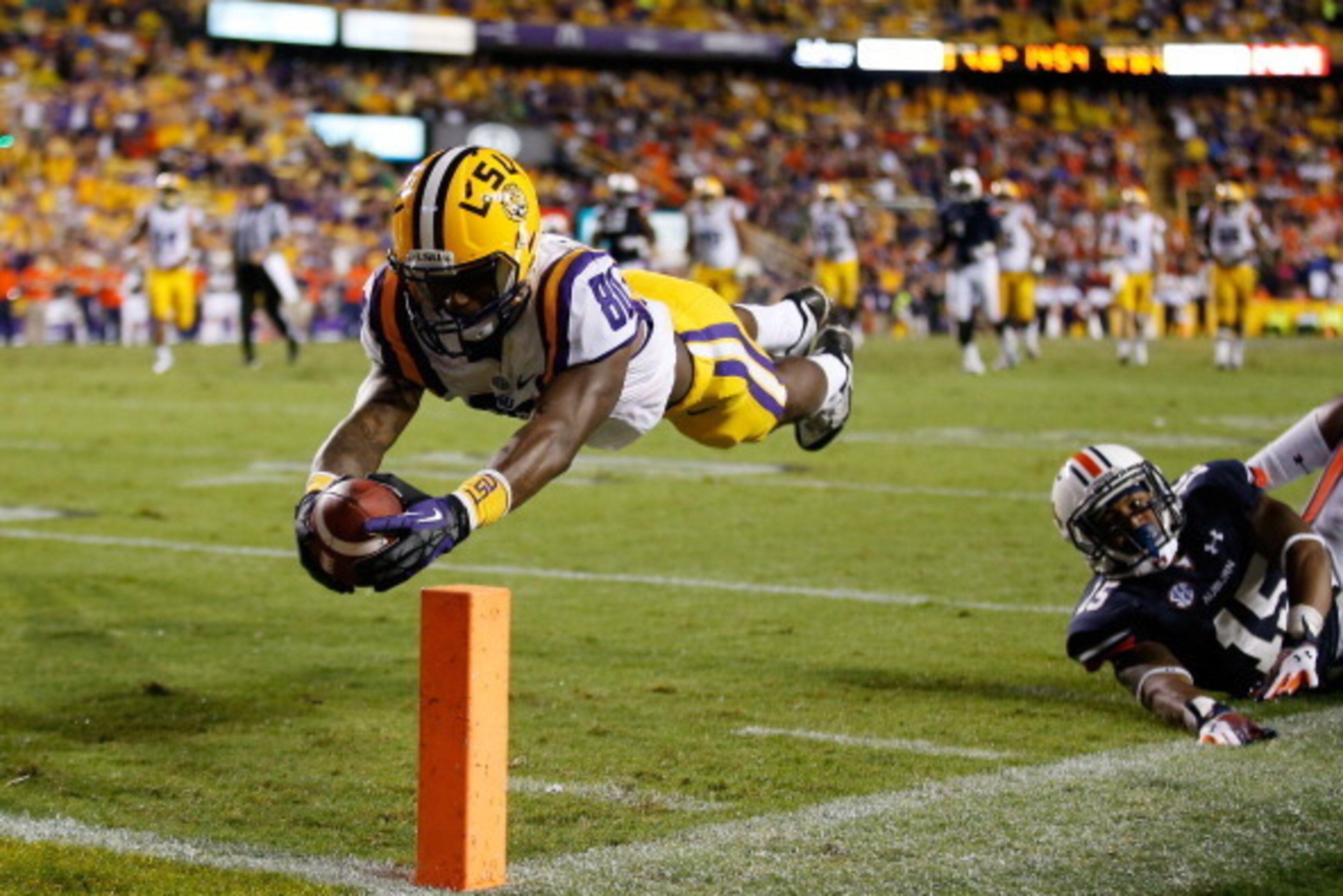 BATON ROUGE, LA - SEPTEMBER 21:  Jarvis Landry #80 of the LSU Tigers dives for a touchdown after avoiding a tackle by Joshua Holsey #15 of the Auburn Tigers at Tiger Stadium on September 21, 2013 in Baton Rouge, Louisiana.  (Photo by Chris Graythen/Getty 