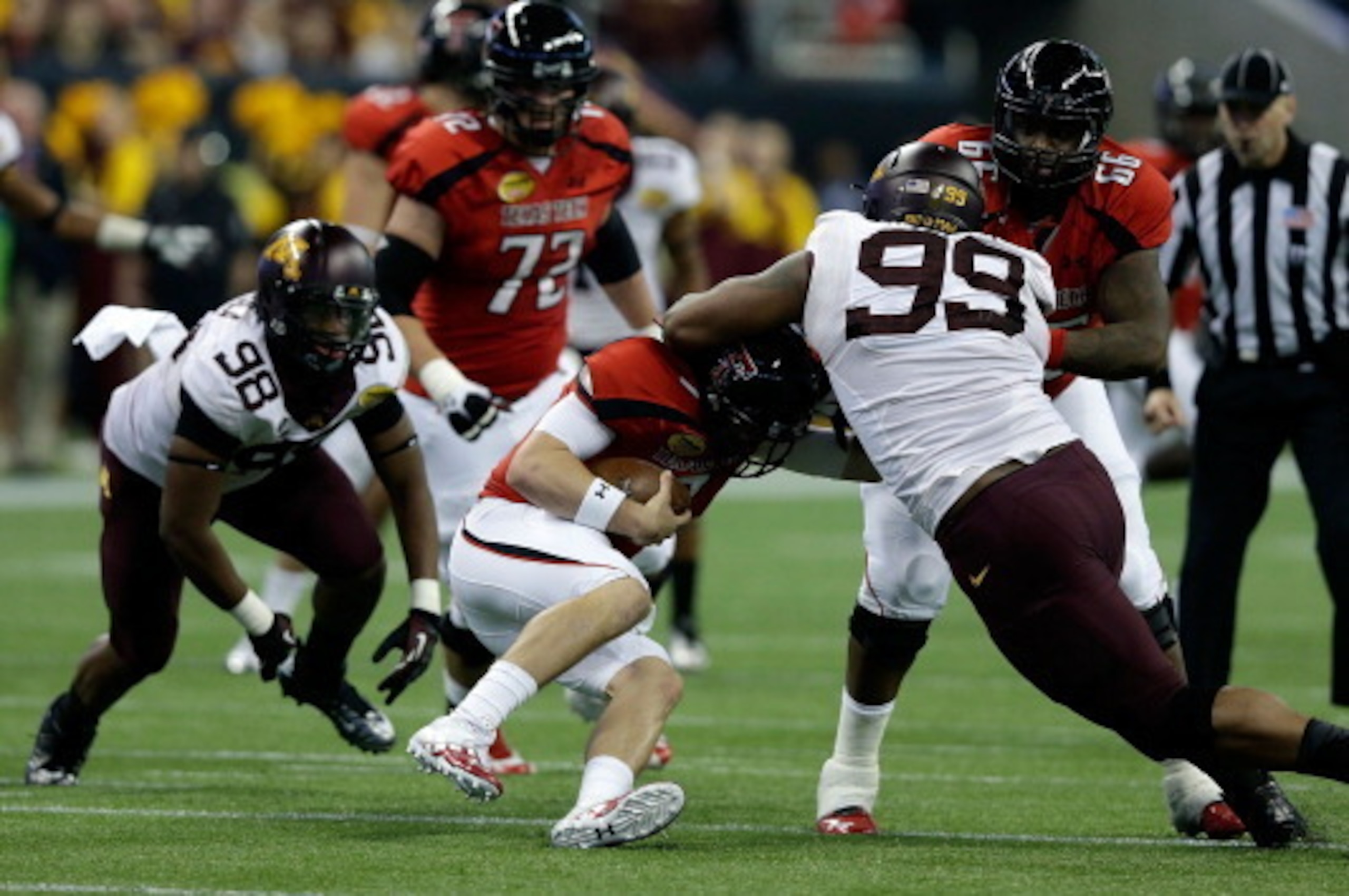 HOUSTON, TX - DECEMBER 28:  Seth Doege #7 of Texas Tech is sacked by Ra'Shede Hageman #99 of Minnesota during the Meineke Car Care of Texas Bowl at Reliant Stadium on December 28, 2012 in Houston, Texas.  (Photo by Scott Halleran/Getty Images)